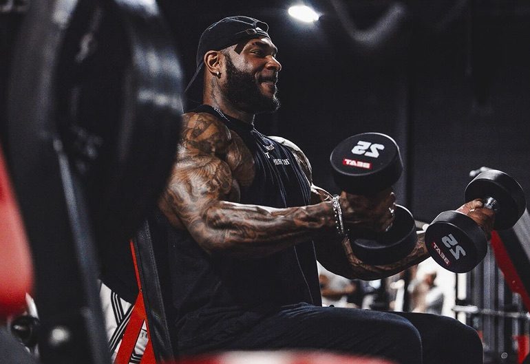 Coach Jae training with a dumbbell