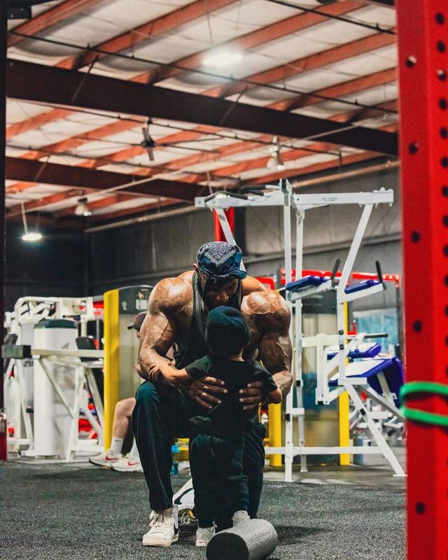 Coach Jae kneeling beside his son in the gym